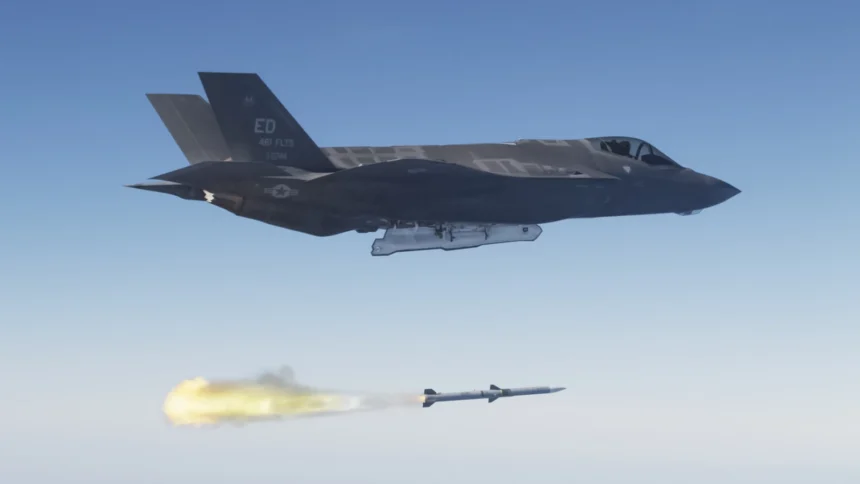 US Air Force F-35A stealth fighter flying above a just-fired AIM-120 AMRAAM missile trailing flame over the Pacific