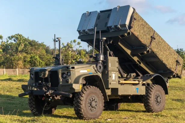 NMESIS anti-ship missile launcher with its twin missile pods raised, parked on grass at Basco in the Philippines
