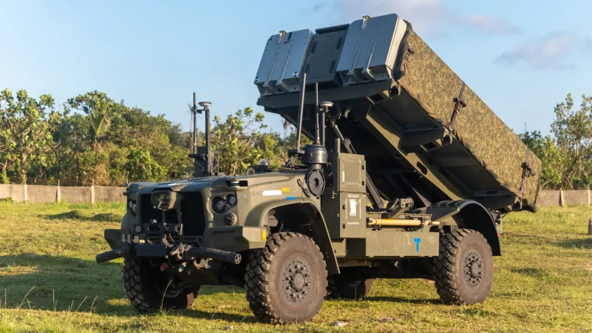 NMESIS anti-ship missile launcher with its twin missile pods raised, parked on grass at Basco in the Philippines