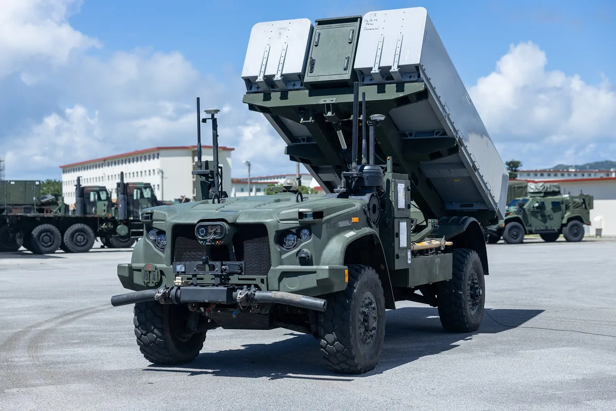 Front view of an NMESIS launcher with its missile pods raised on a paved lot at Camp Hansen, Okinawa