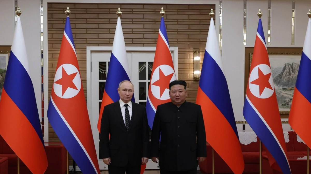 Vladimir Putin and Kim Jong Un in front of Russian and North Korean flags in Pyongyang, June 2024