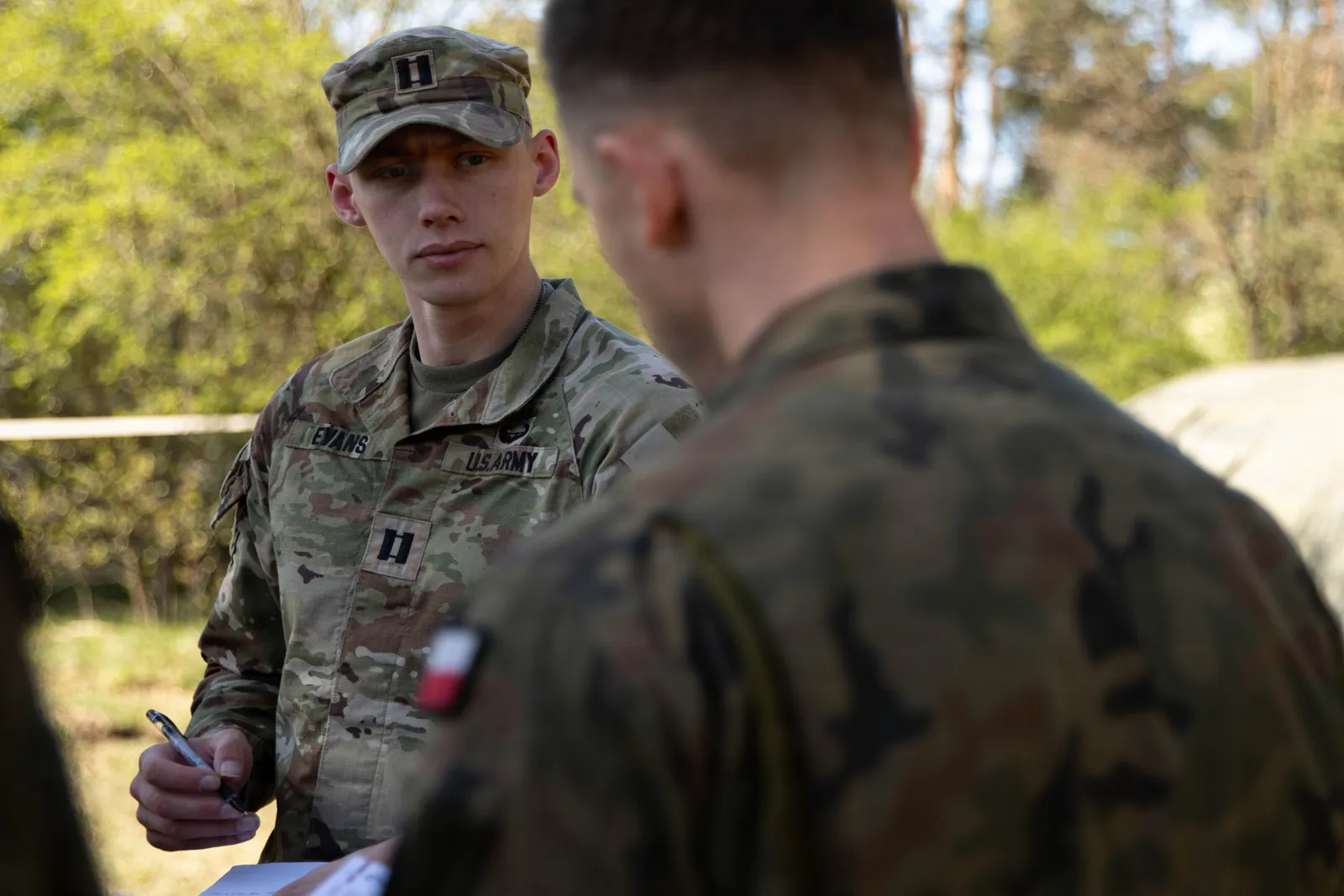 US Army captain and Polish soldier discuss plans during exercise Saber Strike in Poland